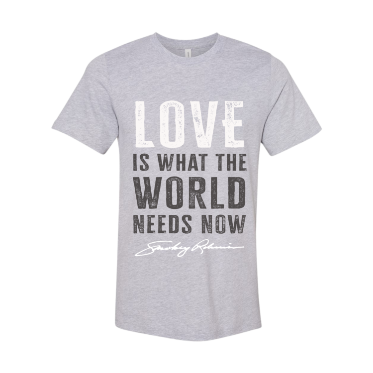 Gray t-shirt with 'LOVE IS WHAT THE WORLD NEEDS NOW' text on a white background